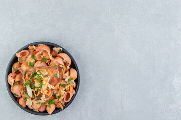 A plate with delicious macaroni and fried meat