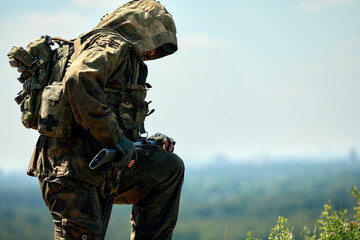 Fototapeta premium Full military experience - One day commando - running through the water with automatic rifle replica