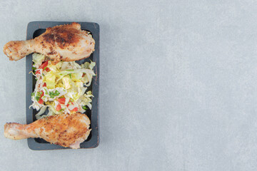 A wooden board of chicken fried meat with lettuce