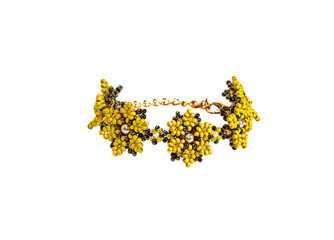 Women's bracelet, woven of gold and yellow beads. Isolated on a white background.