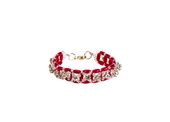 Women's bracelet, woven of gold and red beads. Isolated on a white background.