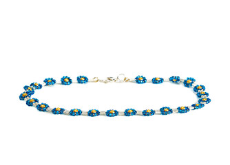 Women's bracelet, woven of white and blue beads. Isolated on a white background.