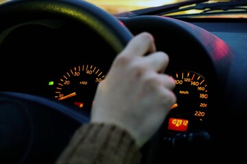 Closeup of a driver's hand and the car dashboard
