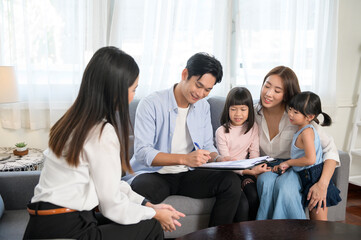 Asian family meeting with female real estate agent or insurance consultant offering promotions , Mortgage, loan, property and medical health insurance concept.