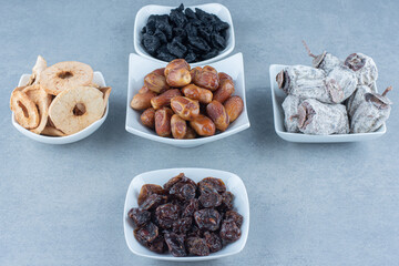 An arrangement of various Turkish delight flavors on a wooden board on marble background