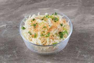 Flavorful vermicelli pasta with green vegetable in the bowl , on the marble background