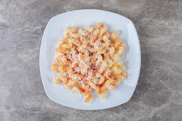 Spicy pasta with tomato sauce , on the marble background