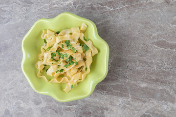 Appetizing classic Italian spaghetti pasta in the bowl , on the marble background