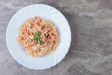 Farfalle pasta with bolognese on the bowl , on the marble background
