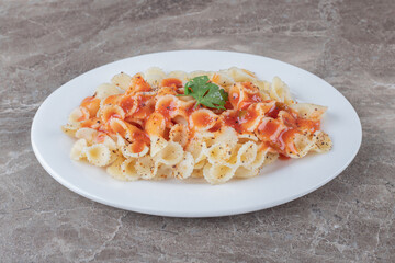 Farfalle pasta with bolognese on the plate , on the marble background