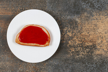 Fried toast with strawberry jam on white plate