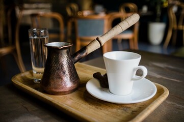 Prepared set of traditional turkish coffee drinking ceremony for breakfast including cup, water and pot