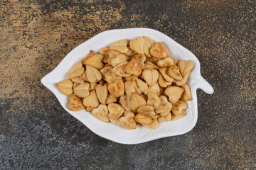 Bunch of heart shaped crackers on leaf shaped plate
