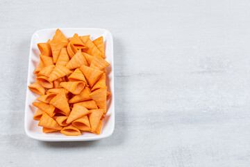 Delicious crunchy chips on white plate