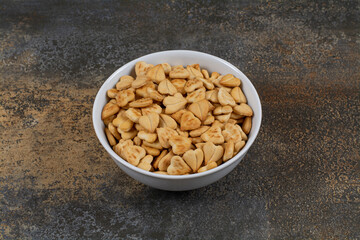 Heart shaped salty crackers in white bowl