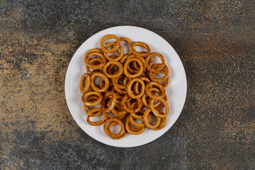 Salted circle pretzels on white plate