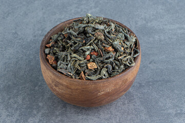 Fototapeta premium A wooden bowl of dried tea leaves