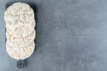 Puffed rice cakes on a wooden dark board
