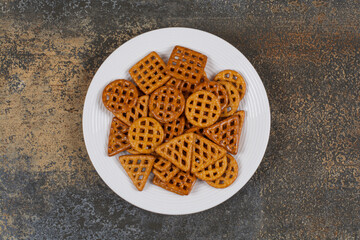 Salted hard crackers on white plate