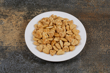 Bunch of heart shaped crackers on white plate