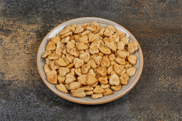 Bunch of heart shaped crackers on ceramic plate