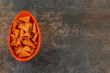 Yummy triangle chips in orange bowl