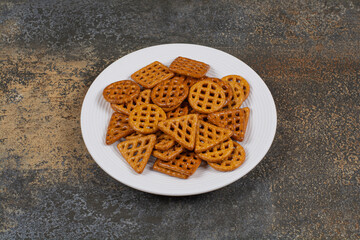 Salted hard crackers on white plate