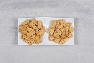Two different kinds of crackers on white plate