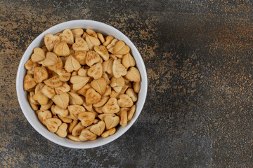 Heart shaped salty crackers in white bowl