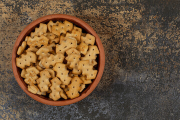 Tasty baked crackers in ceramic bowl