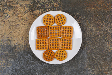 Assortment of salted crackers on white plate