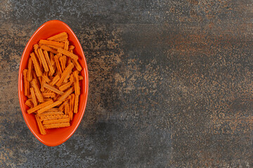 Potato chip sticks in orange bowl