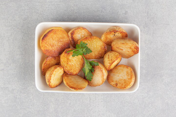 Slices of fried potatoes on white plate