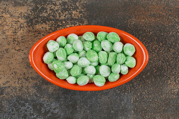 Yummy menthol candies in orange bowl