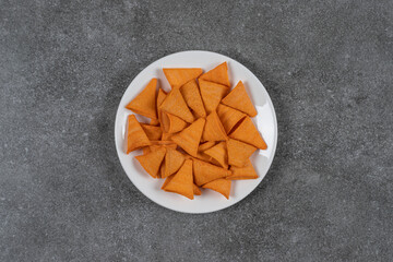 Triangle shaped chips on white plate