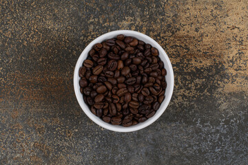 Aromatic coffee beans in white bowl