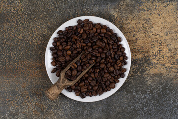 Whole black pepper spices on white plate