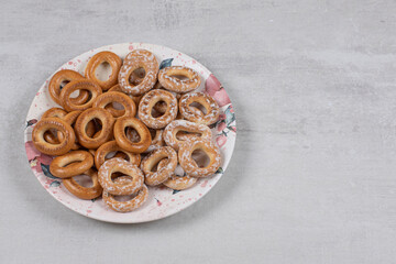 Two types of tasty pretzel rings on white plate