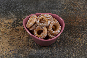 Tasty salted crackers in pink bowl