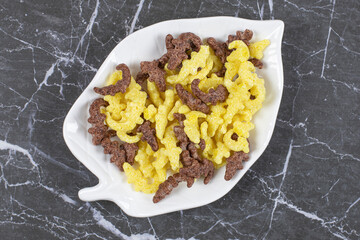 Two types of cereal flakes on leaf shaped plate