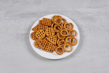 Various salty crackers on white plate