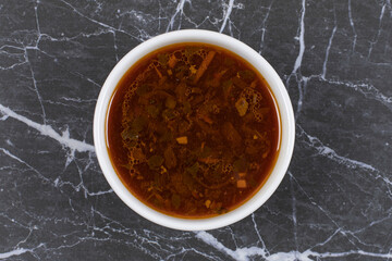 Homemade hot soup in white bowl