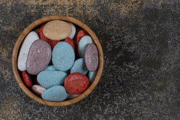 Oval shaped stone candies in wooden bowl