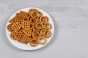 Various salty crackers on white plate