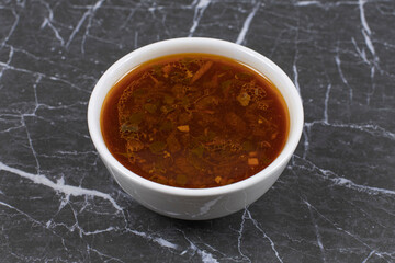 Homemade hot soup in white bowl
