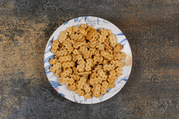 Set of salty crackers on colorful plate
