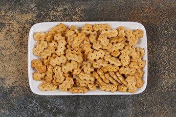 Set of salty crackers on white square plate