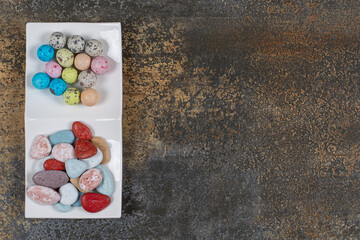 Two types of candies on white plate