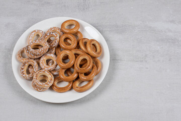 Two types of salted pretzel rings on white plate