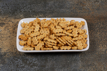 Set of salty crackers on white square plate